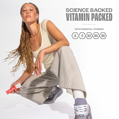 Person posing with vitamin-packed skincare product.